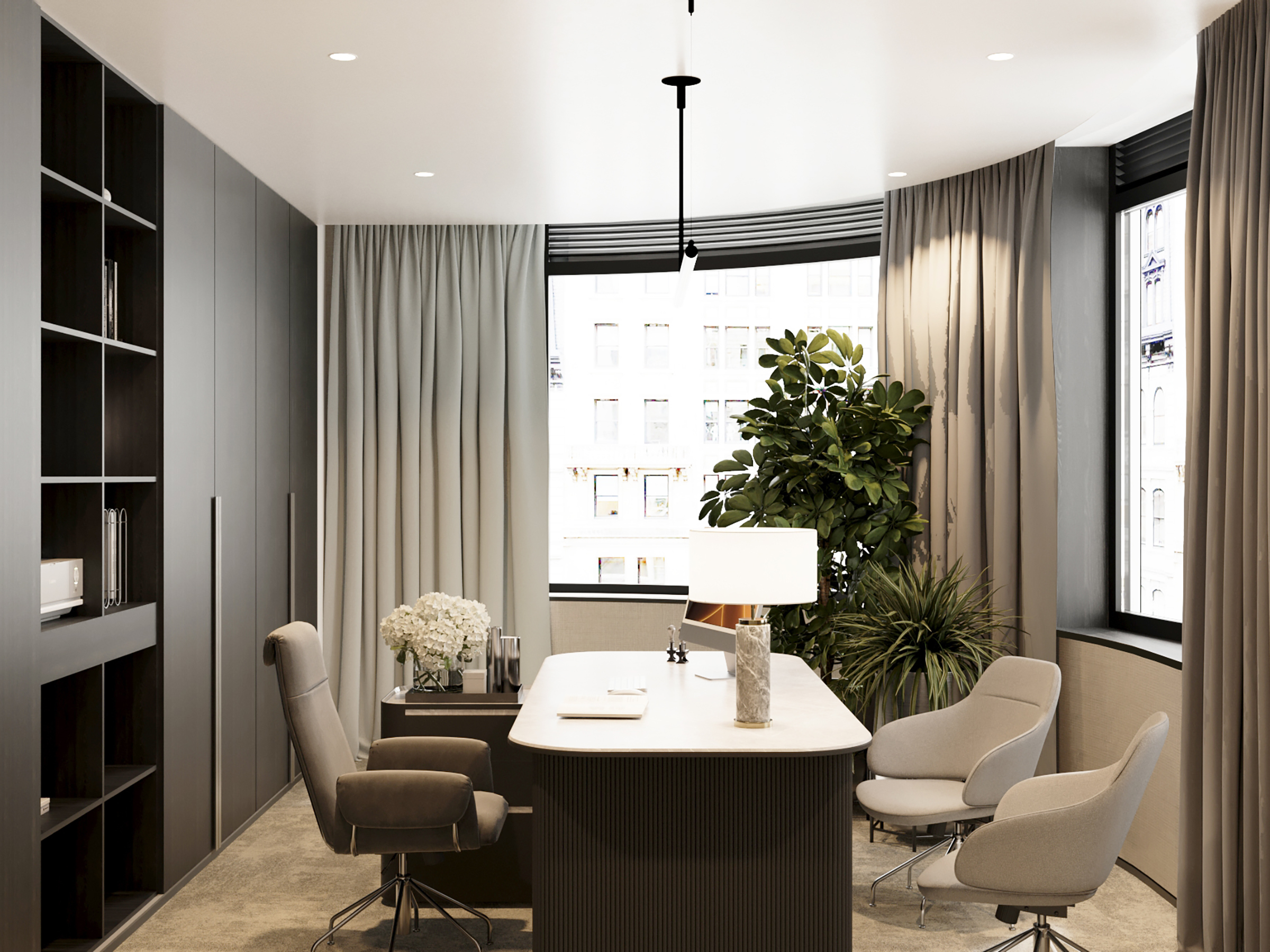 Meeting room with an oval table and upholstered chairs, beside a city window.