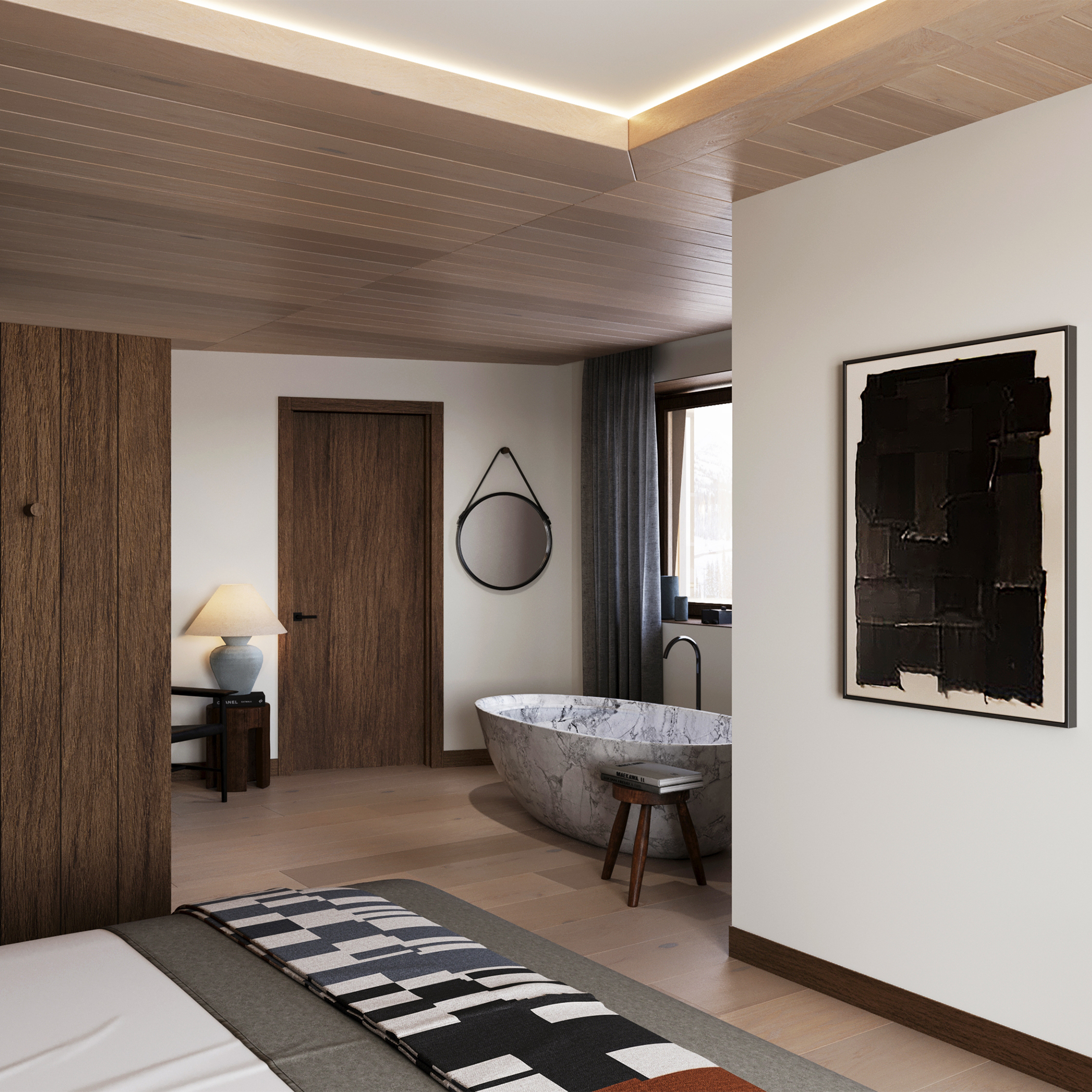Bedroom with a freestanding stone bath beyond a partition, under a black artwork.