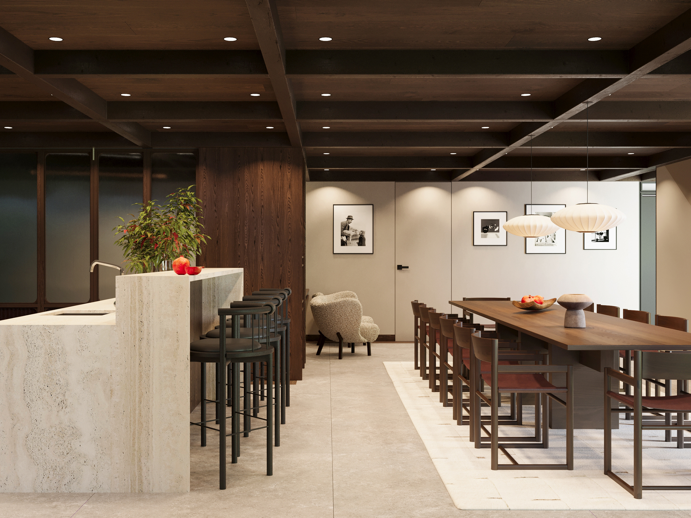 Long dining table and bar counter under pendant lights, hung with framed pictures.