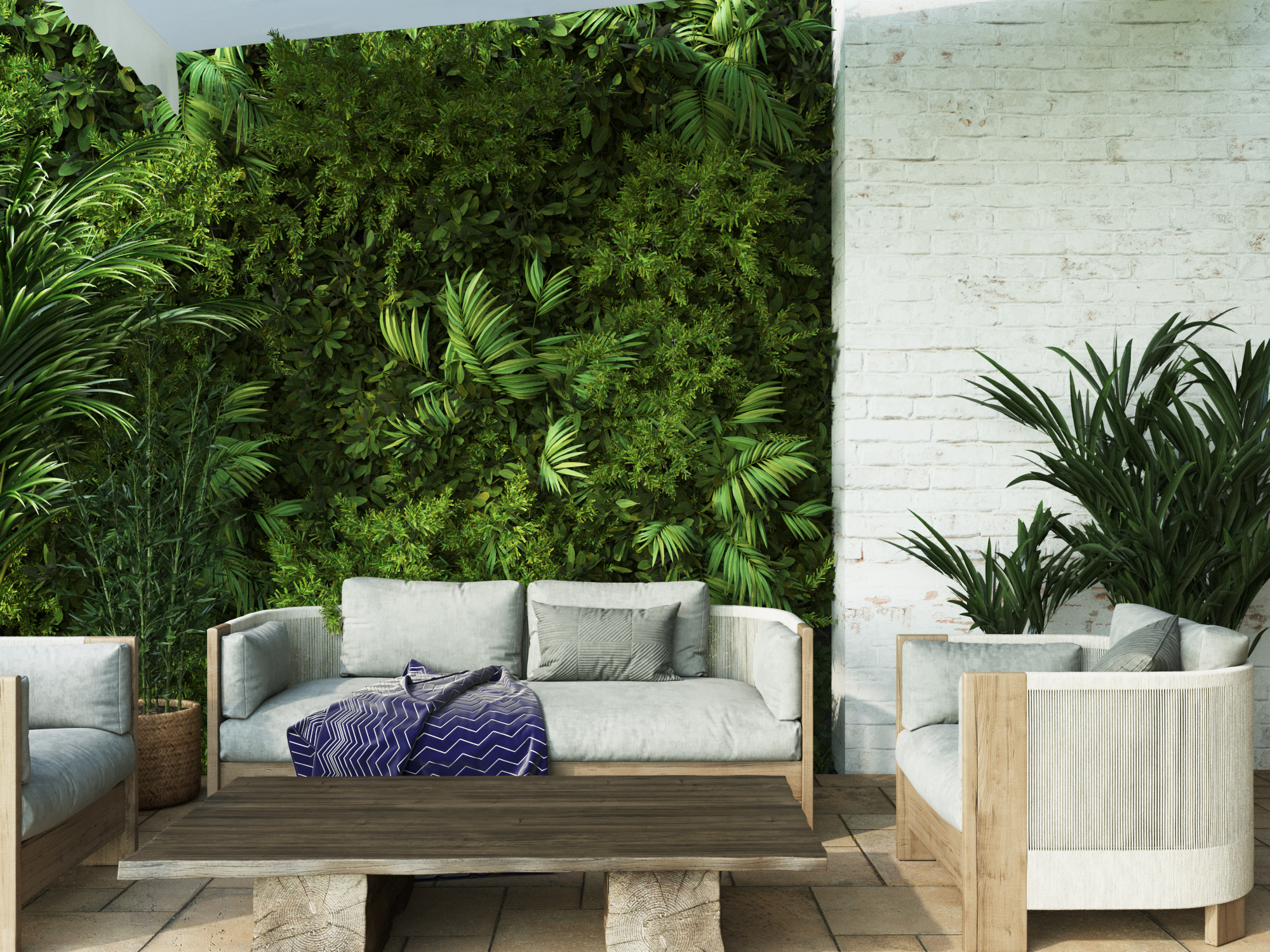 Terrace with a green living wall behind outdoor seating and cushions.