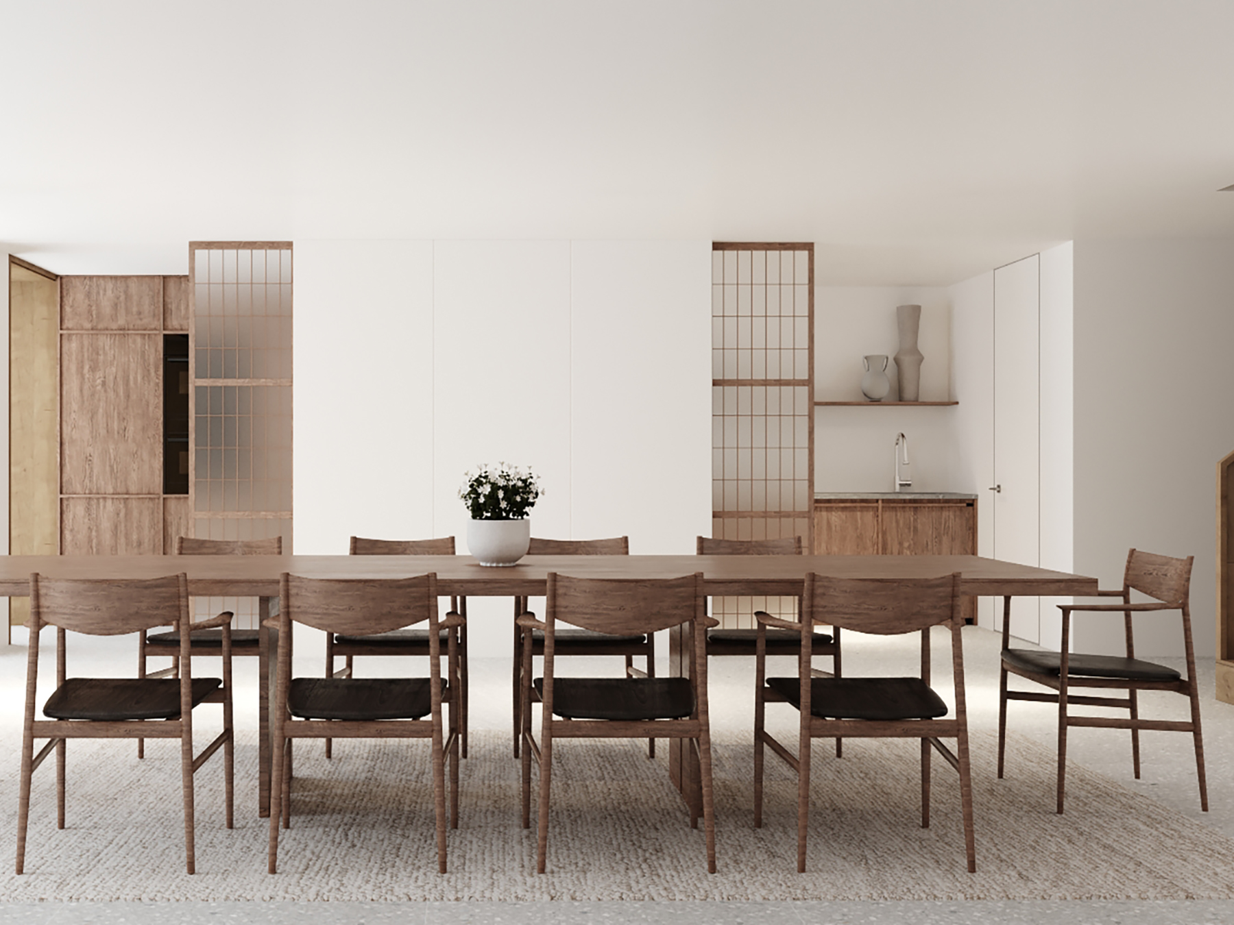 Dining room with a long timber table and chairs, screens dividing off the kitchen.