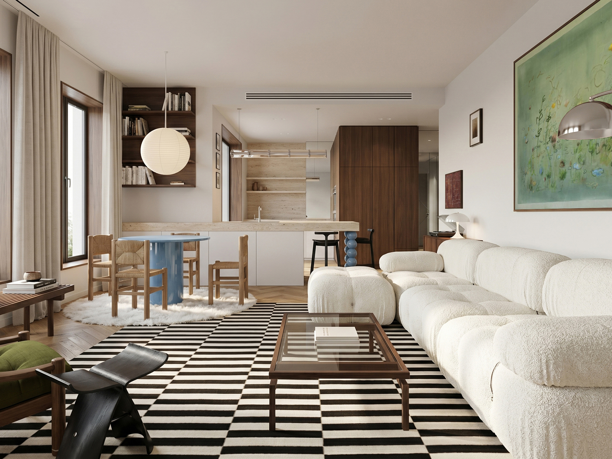 Open-plan living and dining area with a white boucle modular sofa on a black-and-white striped rug, the kitchen behind.