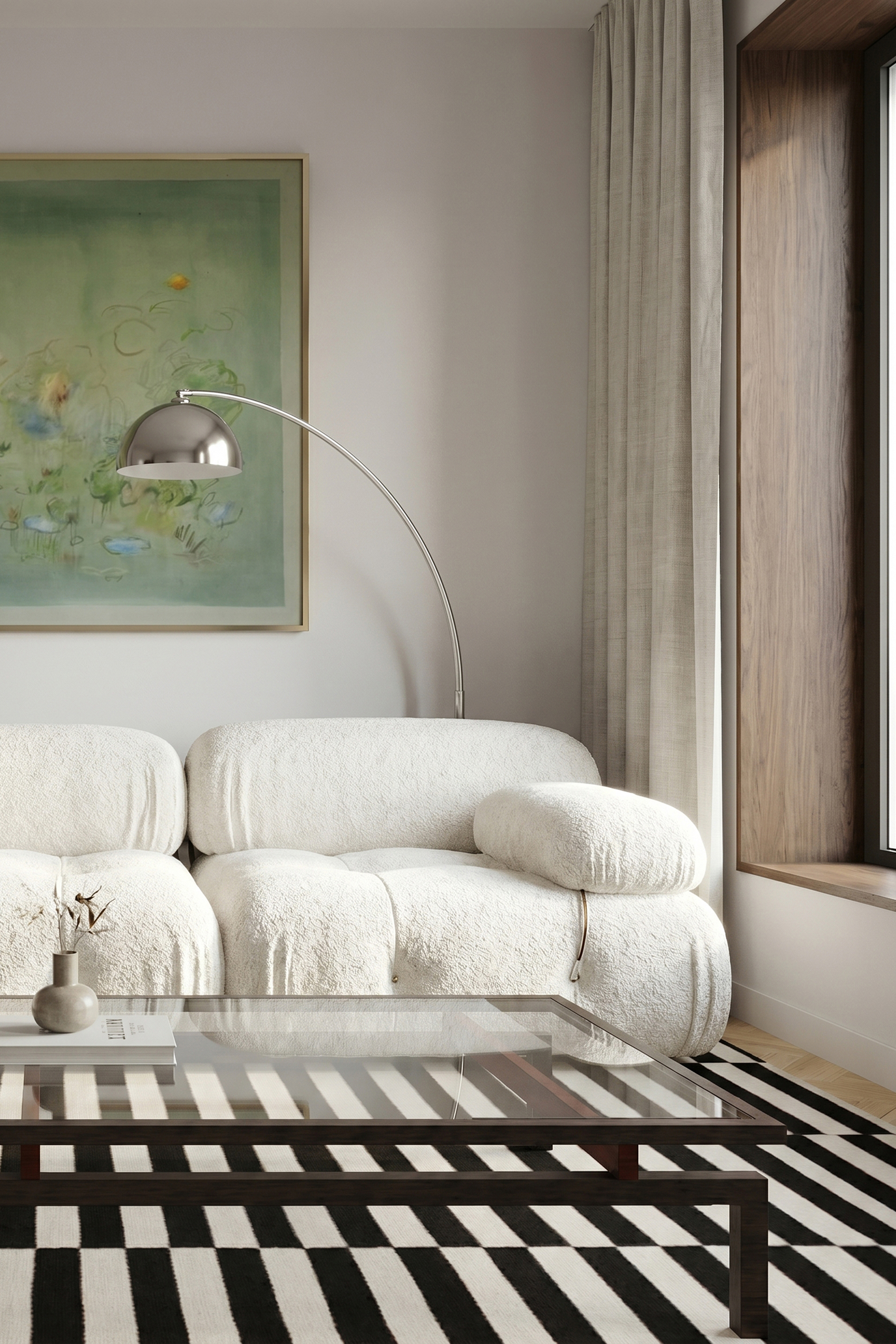 Living room corner with the arc floor lamp and a green artwork above the boucle seating.