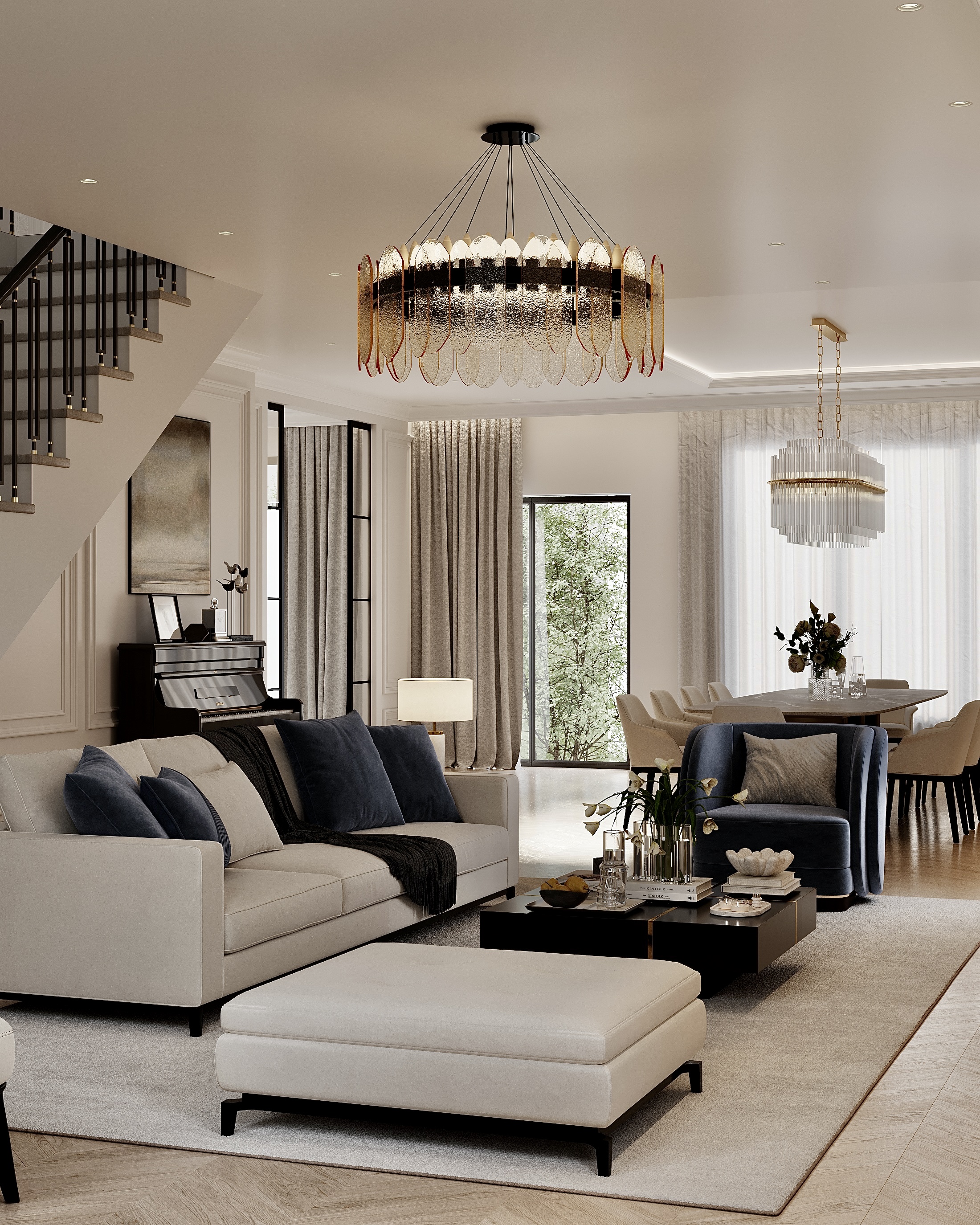 Living room with a pale sectional and ottoman under a chandelier, the stair beyond.