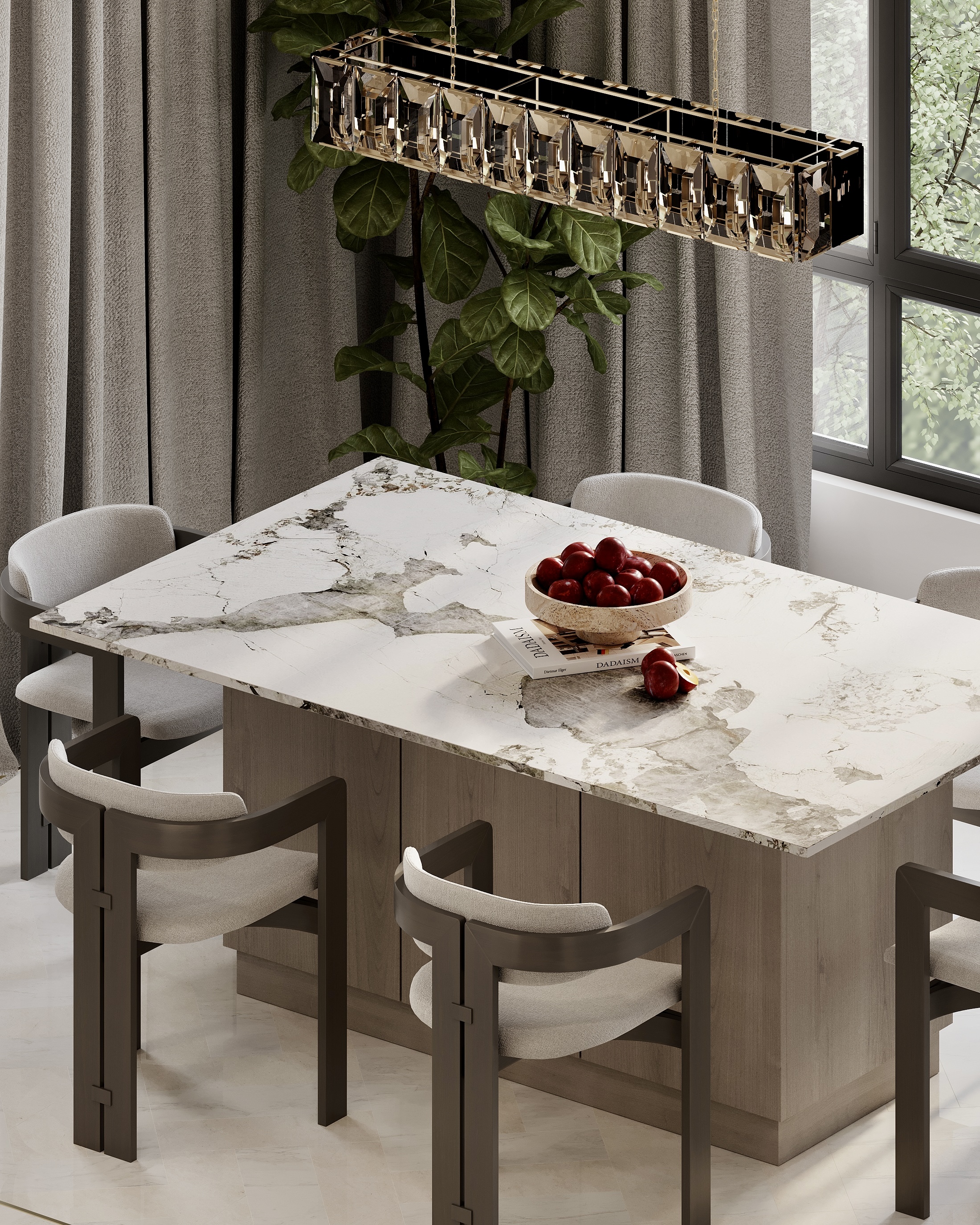 Marble dining table set with a bowl of fruit, under a chandelier by the window.