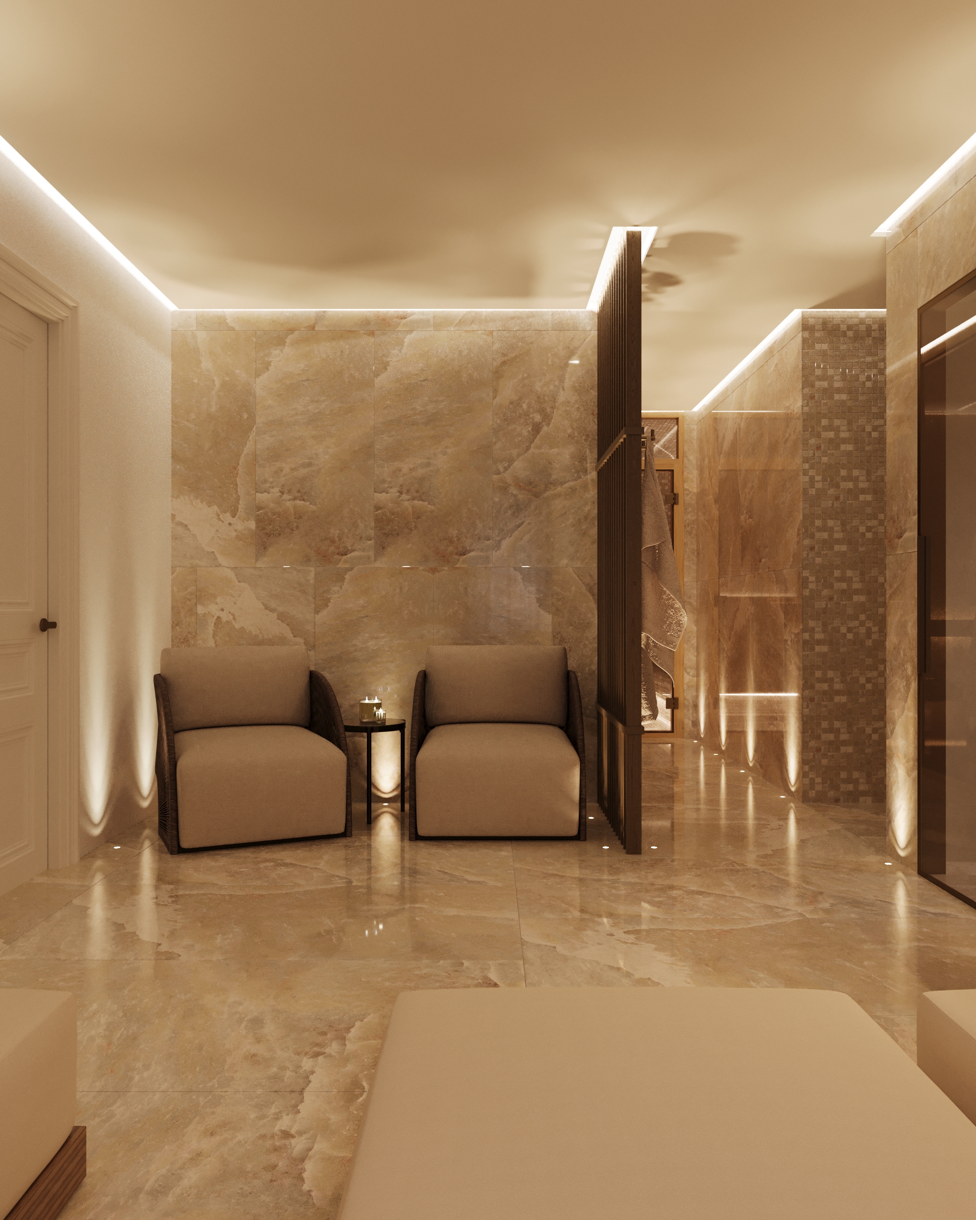 Relaxation area with two armchairs against stone walls, under concealed lighting.