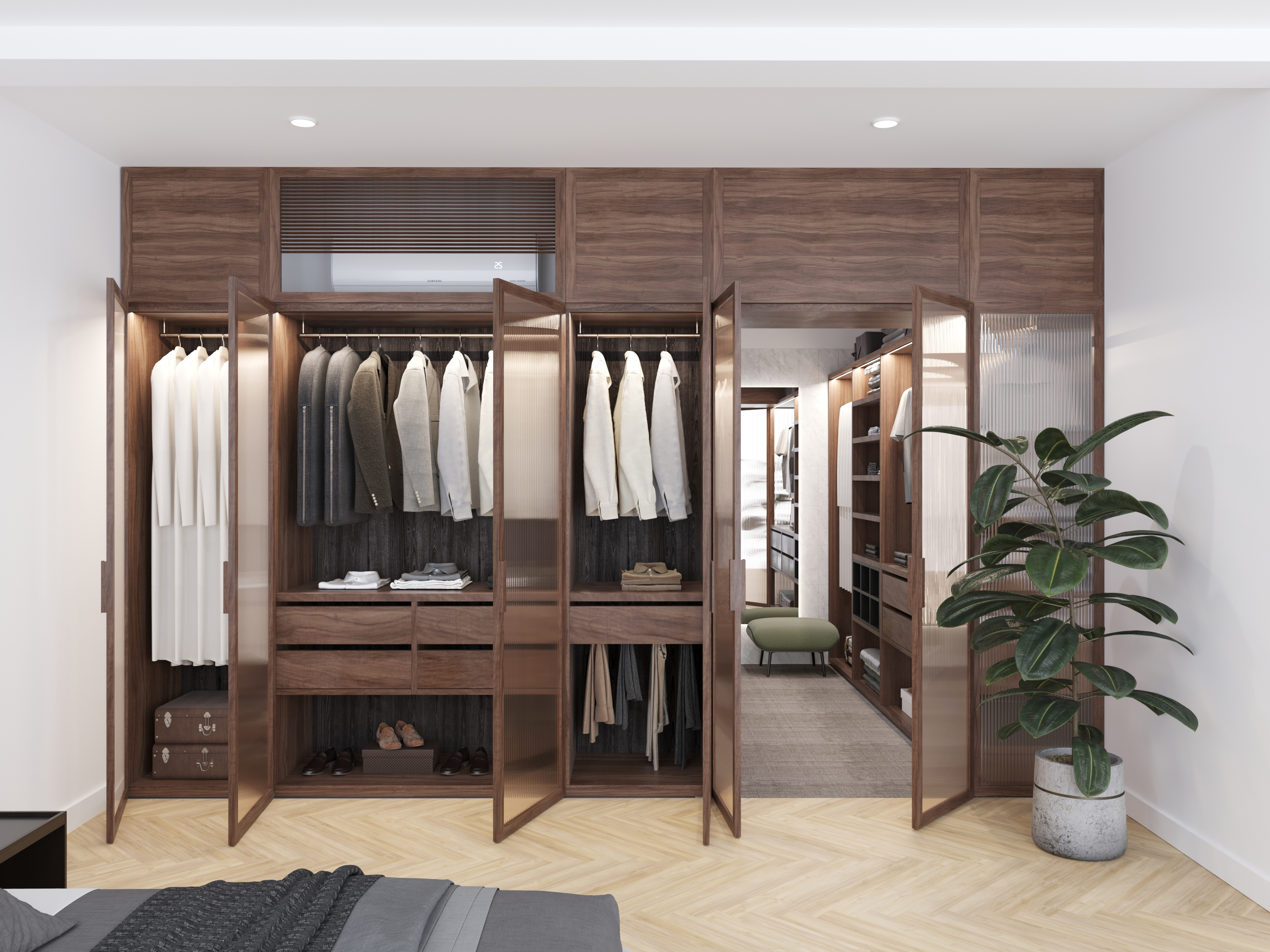 Walk-in wardrobe in timber joinery, with hanging rails, shelves and a potted plant.